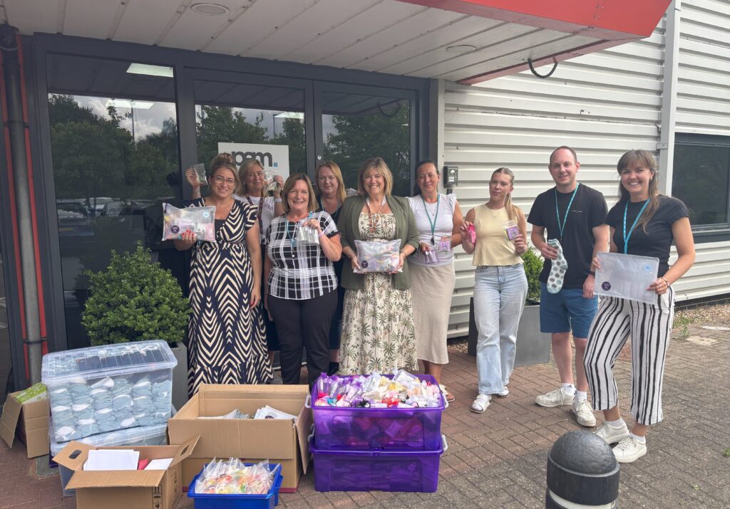 group standing with boxes of materials
